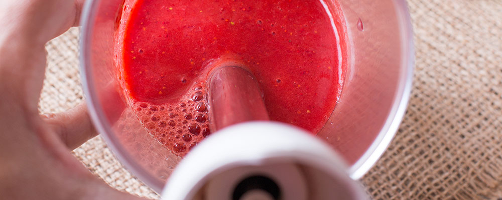 red liquid blended with an immersion blender